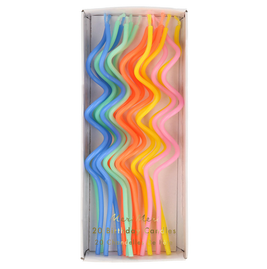 Set of colorful birthday candles in a box on a white background