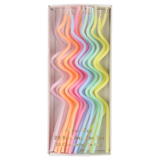 Set of colorful birthday candles in a box on a white background